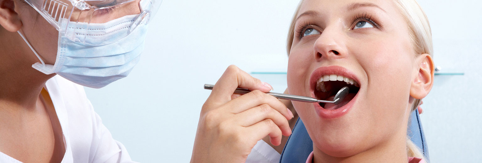 Dentist inspecting a woman's tooth